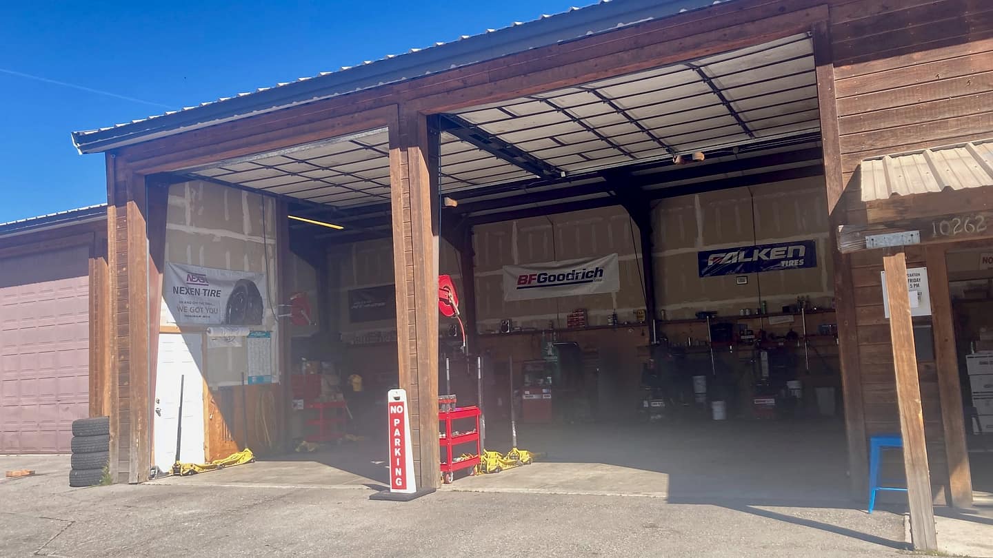 The two open service bays at Truckee Tire on West River Street, with Nexen, BFGoodrich and Falken banners on the walls